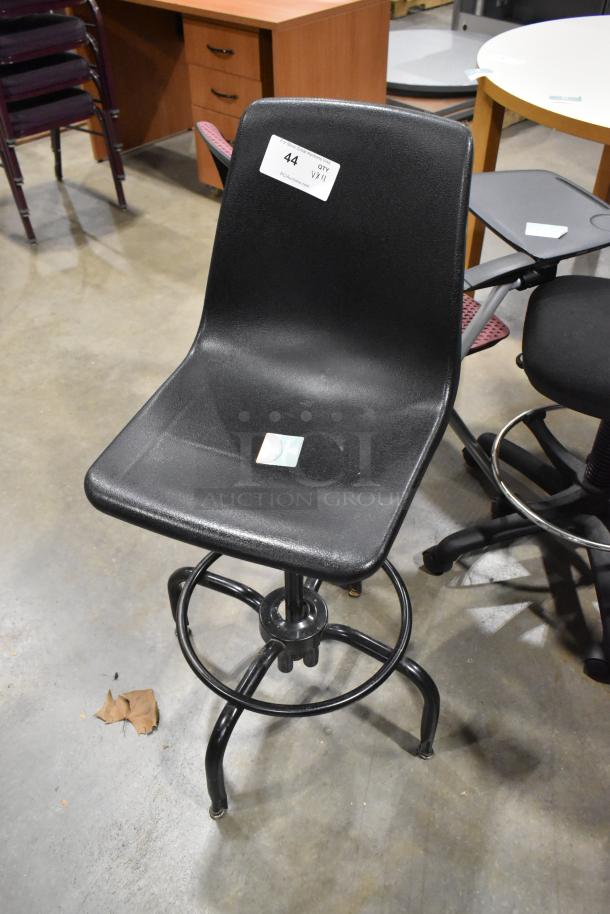 Set of 12 varied chairs, some with casters. Black, durable design. Item tag reads "44 QTY VHI," auction detail visible.