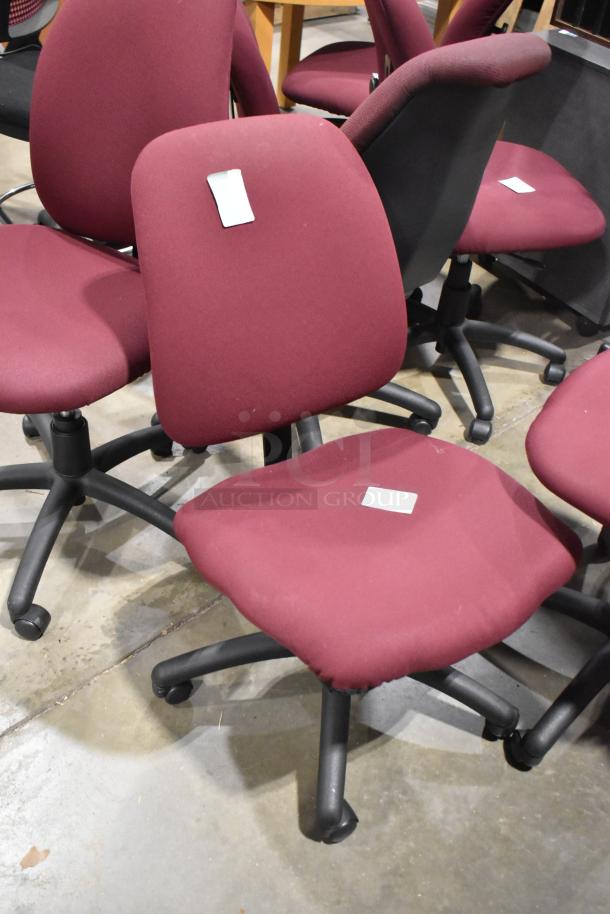 Set of 12 maroon office chairs, some with casters, in used condition; includes visible white tags.