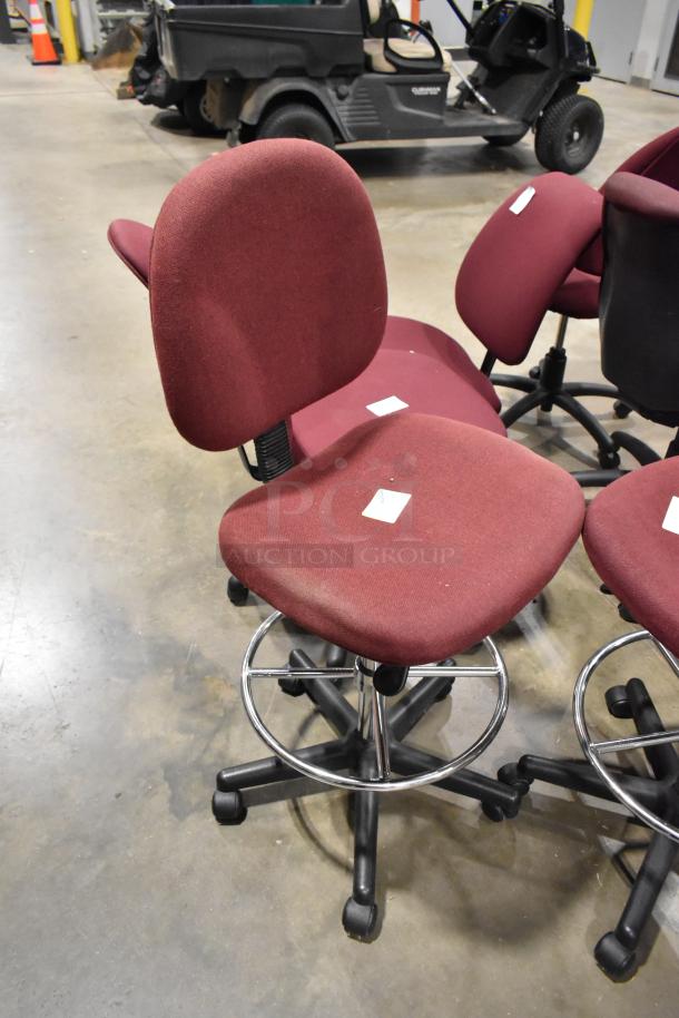 Red office chair with casters, adjustable height, chrome base. Set includes 12 chairs, lightly used, minor wear visible.
