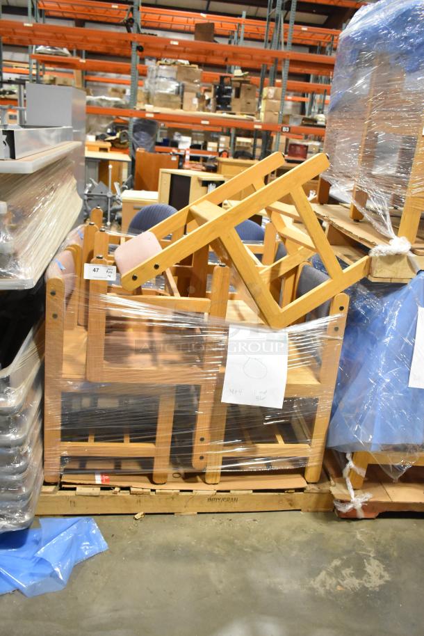 8 wood pattern chairs, stacked and wrapped, visible warehouse setting. Tags indicate "8" and bidding increase. Sturdy condition.