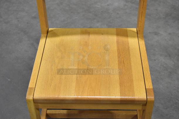 Set of 8 wooden chairs with a light wood pattern. Sturdy construction, excellent condition, ideal for dining or office use.