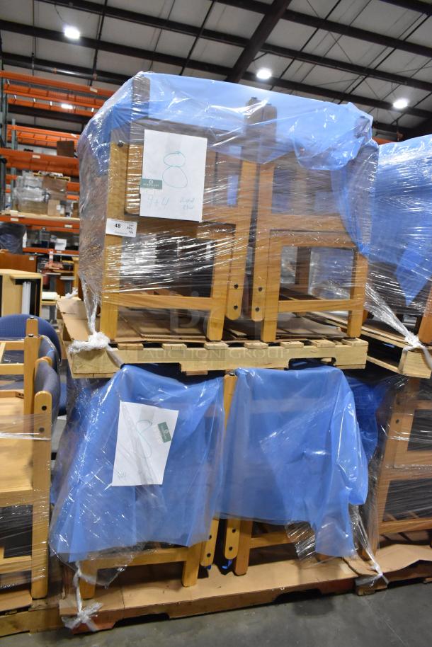 16 wooden chairs wrapped in blue plastic, stacked on pallets in a warehouse. Tags show "8" and "944." Auction lot item.