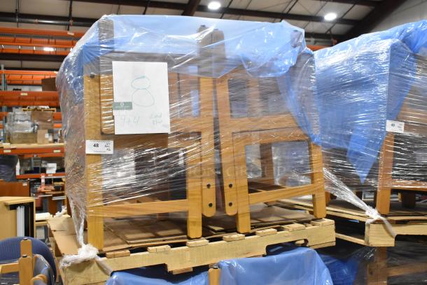16 wood pattern chairs wrapped in plastic, stacked on pallets, auction lot sign visible, excellent bulk condition.