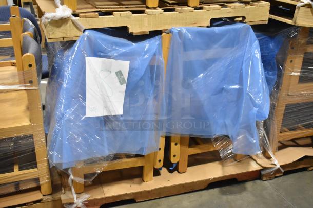 Set of 16 wooden chairs with blue covering, still in packaging. Ideal for bulk purchase. Includes pallet for transport.