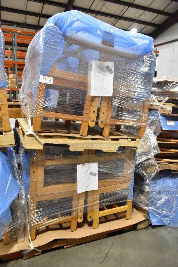 16 wood pattern chairs stacked and shrink-wrapped on pallets, labeled for auction, in a warehouse setting.