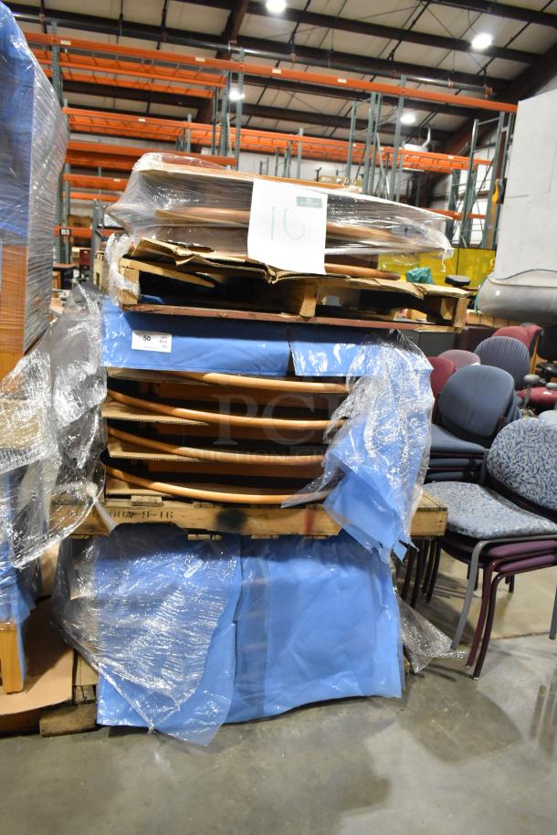 Stack of 10 wood pattern tables wrapped in plastic, placed on a pallet. Warehouse setting with visible label marked "10."