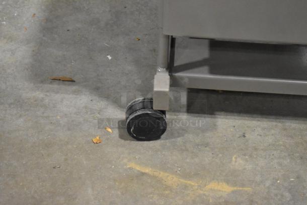 Two wood-pattern desks on casters, ideal for mobility. Sold in pairs. Good condition, suitable for office use.