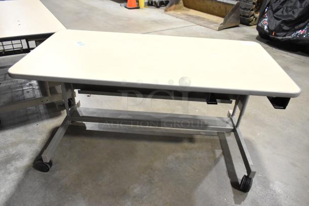 2 wood pattern desks on casters, beige top, metal legs, good condition, mobile design for flexible use.