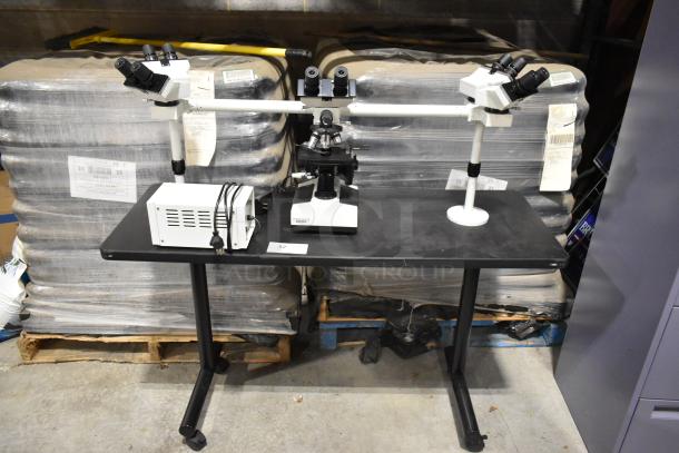 Black table with Pro Microscope XSZ-510D, featuring 5 head multi-viewing for teaching. Includes power supply unit. Excellent condition.