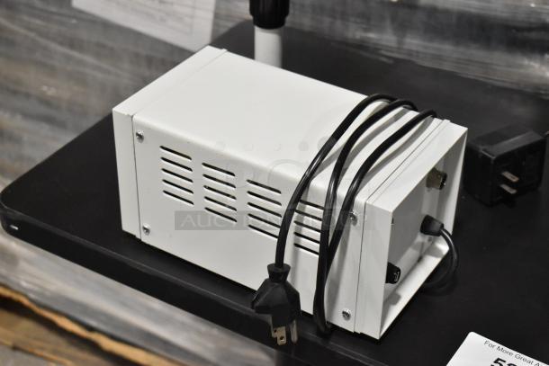 Black table with Pro Microscope XSZ-510D, featuring 5 head multi-viewing microscope. Power supply shown.