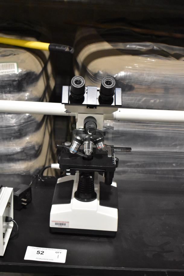 Black Table with Pro Microscope XSZ-510D, features 5-head multi-viewing for teaching. Excellent condition, labeled "52 QTY 1".