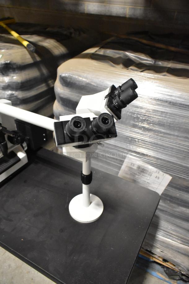 Black table with Pro Microscope XSZ-510D, featuring a 5-head multi-viewing setup. Ideal for teaching purposes.