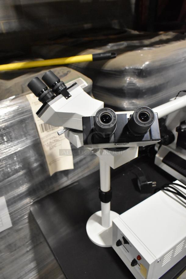 Black table with a Pro Microscope XSZ-510D, featuring five viewing heads for teaching purposes, in excellent condition.