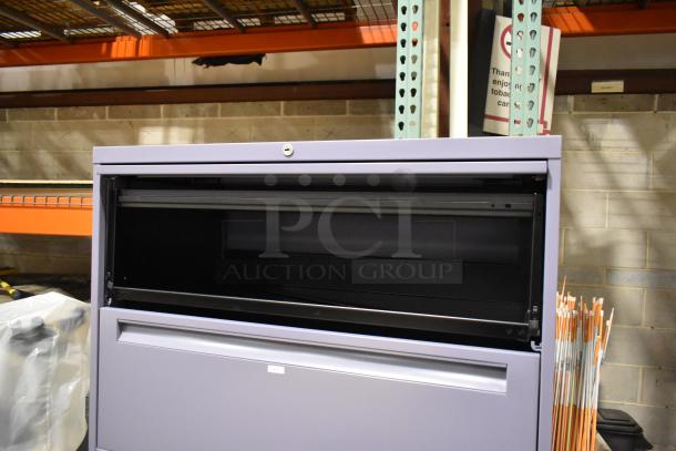 Metal filing cabinet with four drawers and one door, featuring a lockable compartment, in good condition.