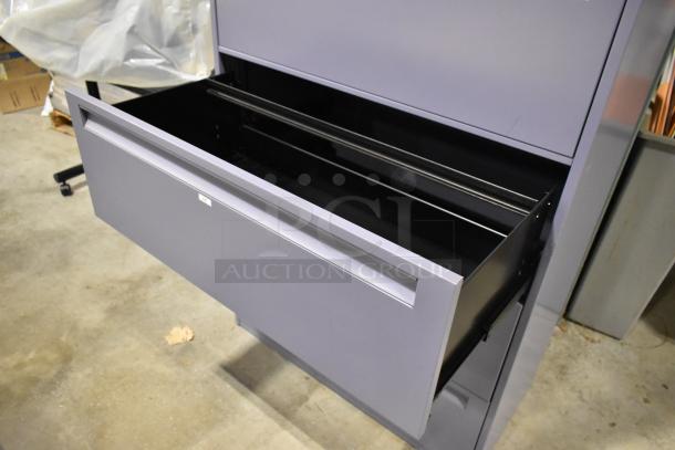 Metal filing cabinet with 4 drawers and 1 door, grey color, open top drawer, clean condition, visible label "129".