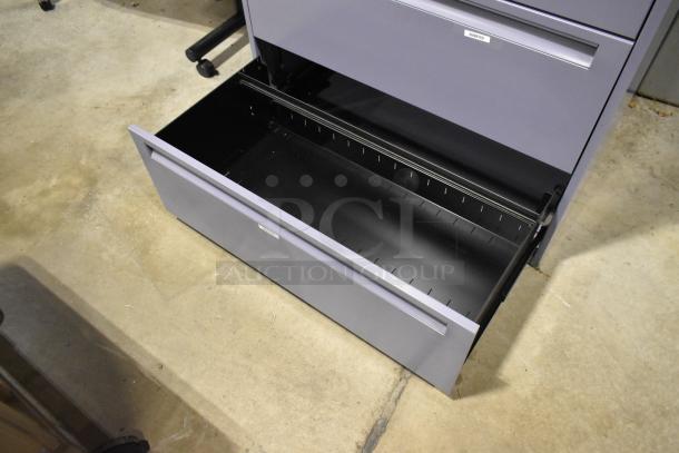 Metal filing cabinet with 4 drawers and 1 door, open lower drawer, gray finish, good condition, label indicating "DIAMETER."