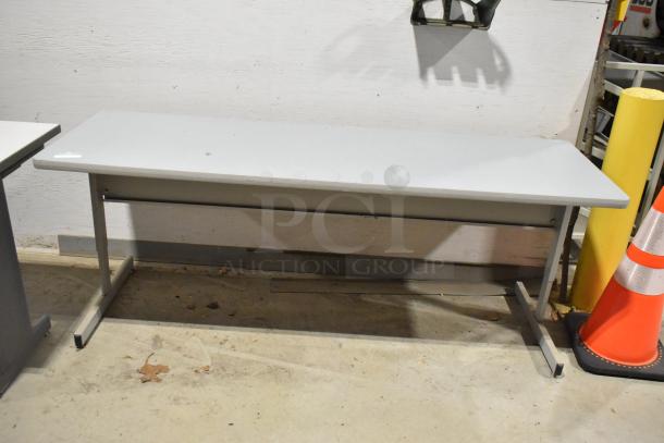 Two gray desks with metal legs in good condition, suitable for office use. Auction lot offers twice the quantity bid.