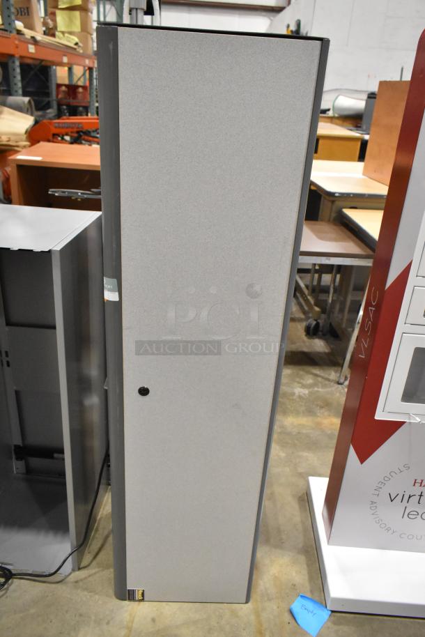 Two gray overhead cabinets for desks, tall design, metallic finish, with a small black handle and visible lower label.