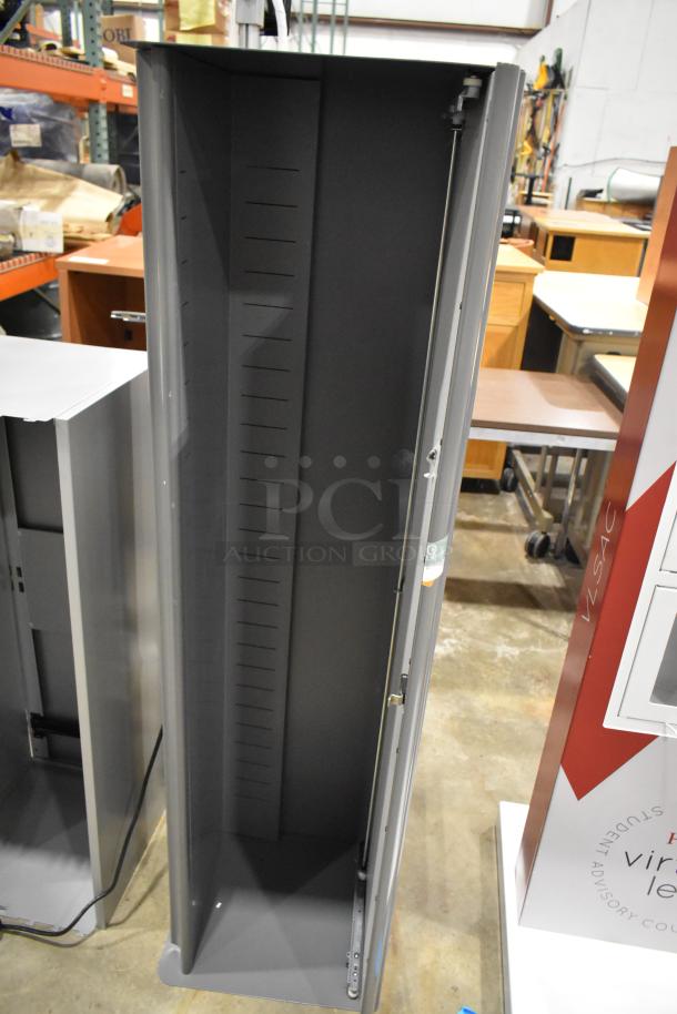 Gray overhead desk cabinets, two units, industrial design, vertical orientation, metal construction, used condition.