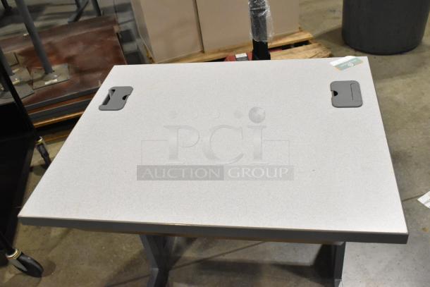 Black 3-tier cart on casters and gray desk. Gray desk with cable cutouts; both in good condition.