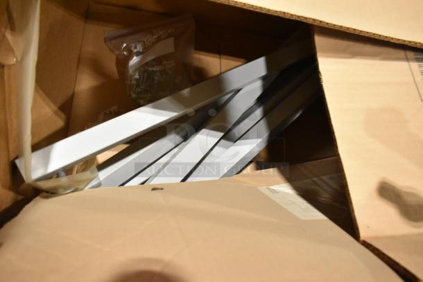 Two pallets with assorted items including white metal table legs, possibly new in box, with a bag of screws.