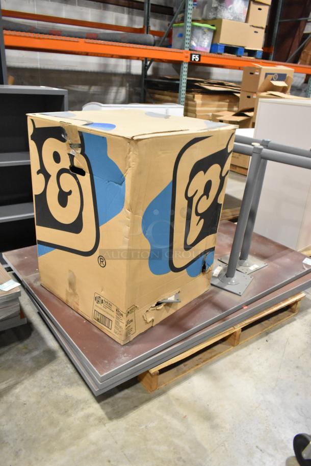 2 pallets with various items including tabletops and table legs. Large box with logo, worn condition. Auction offers double bid value.