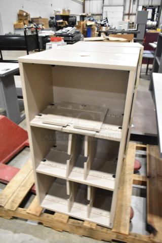 Beige bookshelf with adjustable shelves, excellent condition. Sturdy construction, placed on a wooden pallet in a warehouse.