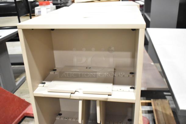 Tan metal bookshelf with adjustable shelves; clean and sturdy. Part of a lot including two desks. Ideal for office use.