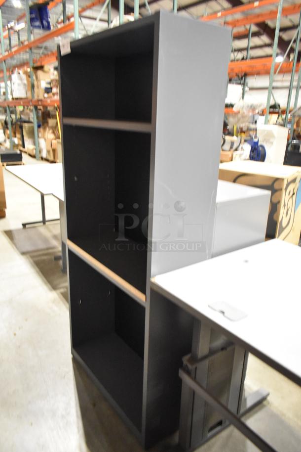 Tall black bookshelf with two main shelves. In good condition, ideal for storage or display in an office or home setting.