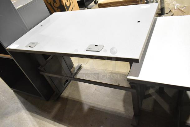 Three gray desks with durable surfaces and integrated cable management. Slight wear. Auction includes all three units.