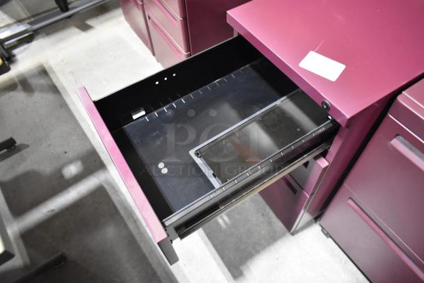 Six maroon metal filing cabinets, mix of 2 and 3 drawers, open drawer view, good condition, visible label tag.
