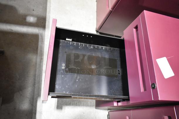 Maroon metal filing cabinet with open drawer, visible wear. Contains both 2-drawer and 3-drawer units. Includes label.