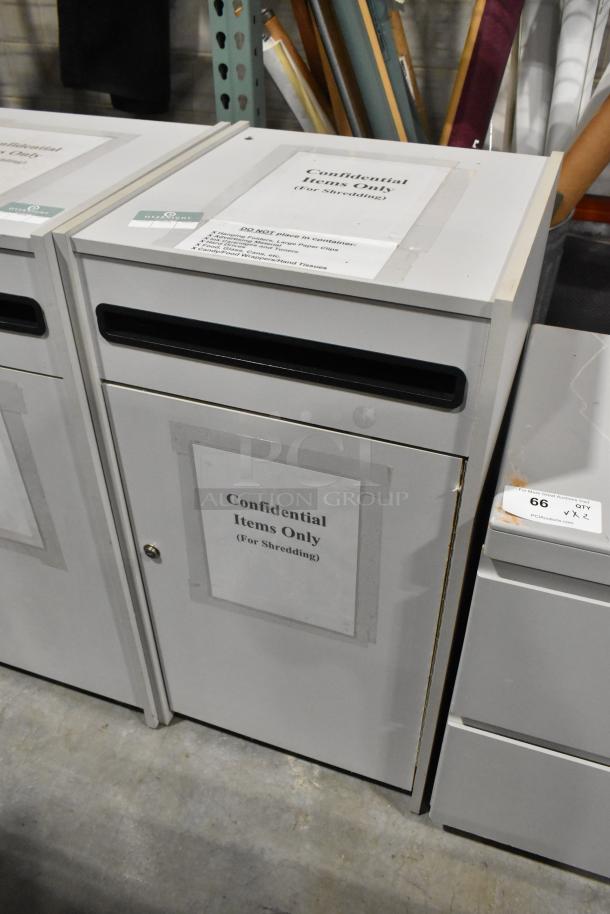 White drop cabinet for shredding documents, labeled "Confidential Items Only" with a top slot, showing minor wear.