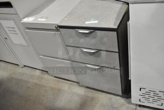 Two filing cabinets: one with three drawers and another with two drawers. Light gray, metal handles. Good condition.