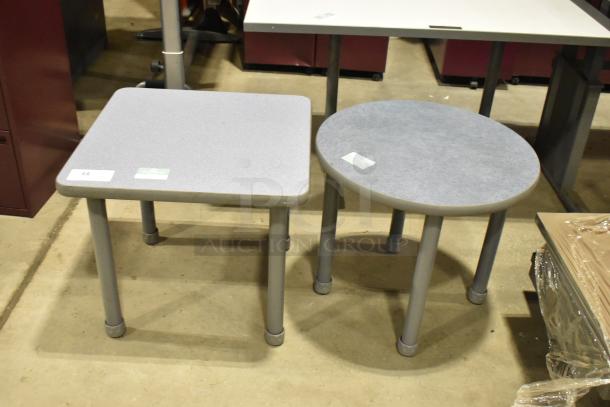 Two gray end tables: one square, one round. Both have gray legs and tabletops. Auction lot with tags attached.