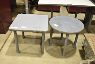 Two gray end tables: one square, one round. Both have gray legs and tabletops. Auction lot with tags attached.