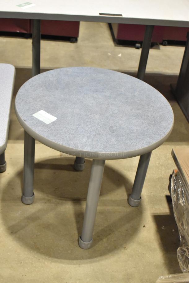 Round gray end table with four legs, solid condition, auction includes this and a square table.