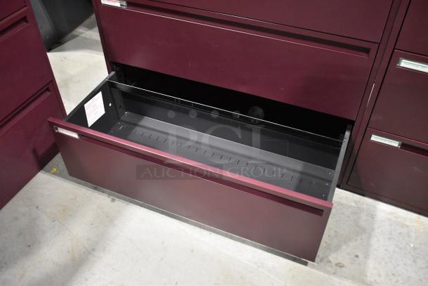 2 maroon metal 3-drawer filing cabinets. Features include sleek design, sturdy construction, and smooth drawer operation.
