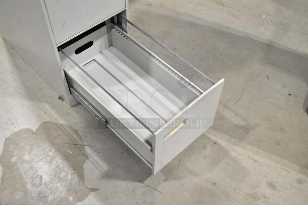Gray metal 4-drawer filing cabinet, open drawer showing full-extension glides, label holder, good condition.