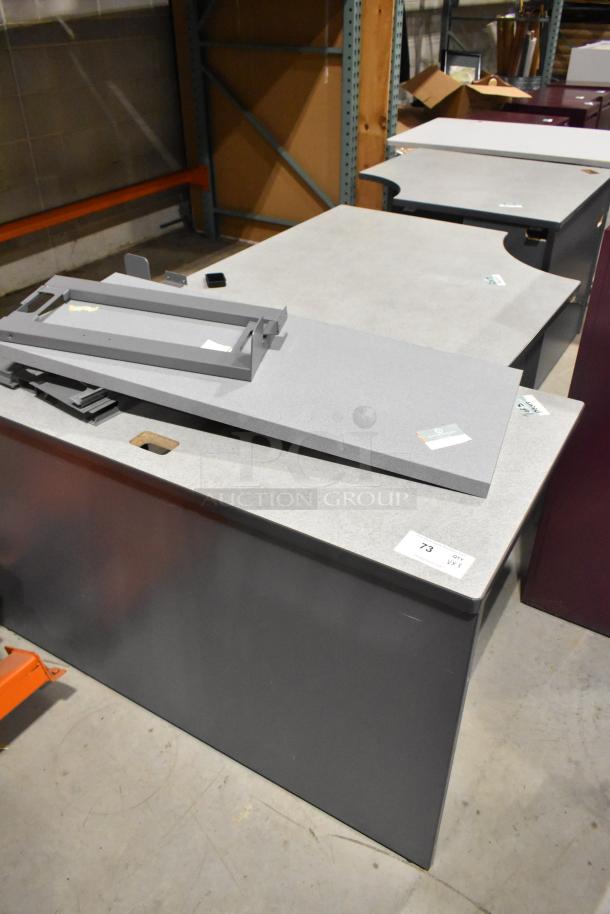 Three gray desk pieces, each with a laminated top and metal frame. Slight wear. Lot marked "73," indicating quantity.