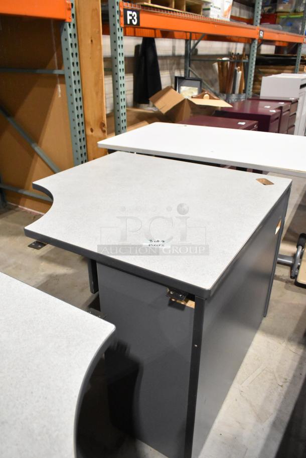 Three gray desk pieces with laminated tops and metal supports, showing minimal wear, labeled "3 of 3 pieces."