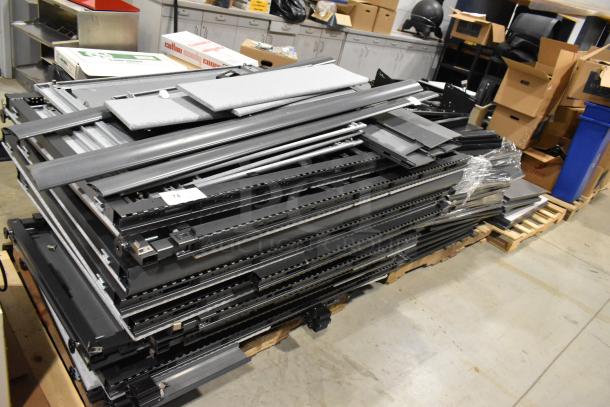 6 pallets with metal pallet racking, gray desk panels; various items stacked, showing industrial components, in used condition.