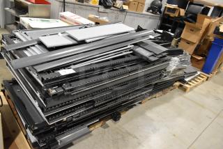 6 pallets with metal pallet racking, gray desk panels; various items stacked, showing industrial components, in used condition.