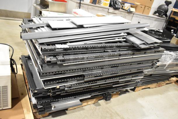 6 pallets of metal pallet racking and gray desk panels, in used condition. Includes diverse office and storage materials.