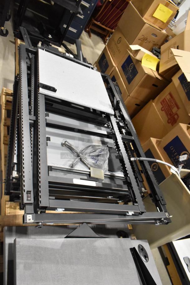 6 pallets of assorted items including metal pallet racking and gray desk panels, stacked and organized, in good condition.