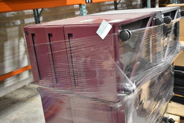 Maroon metal filing drawers wrapped in plastic, featuring three and two-drawer units, showing slight wear.