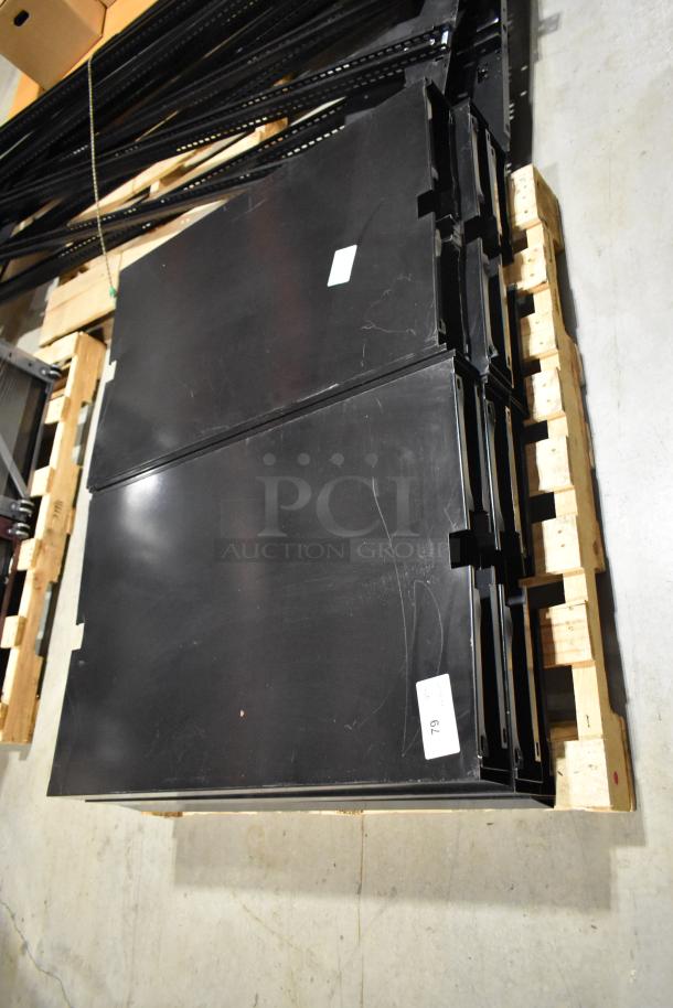 3 pallets of various metal racking pieces, black, stacked on wooden pallets. Includes labels for identification.