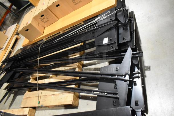 Three pallets of various metal racking pieces, black, in good condition, stacked on wooden pallets, includes chain.