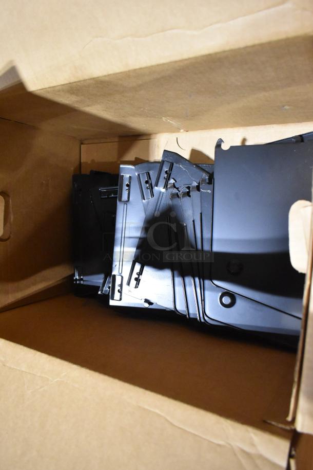 Box containing various black metal racking pieces. Items appear in good condition, suitable for commercial use.