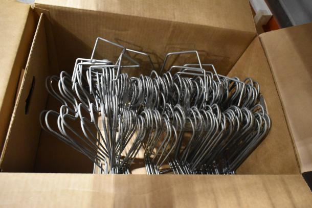 Pallet lot with metal hangers; includes various metal pieces in a cardboard box. Item condition is mixed.